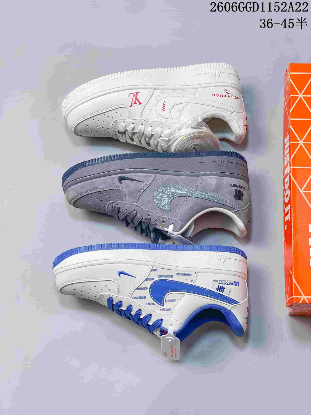 Pair of white low-top sneakers with blue accents displayed on a box.