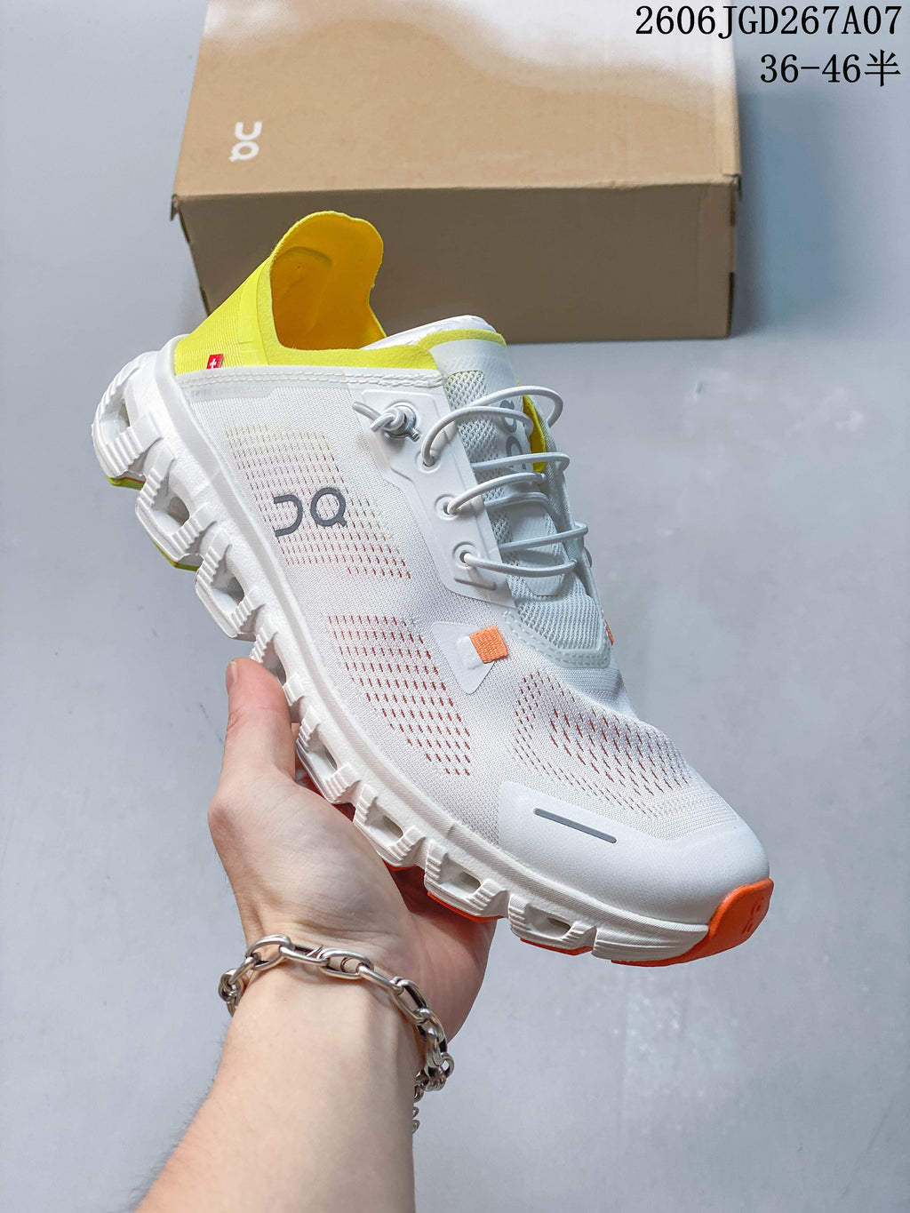 Angled side view of the white sneaker with its segmented outsole