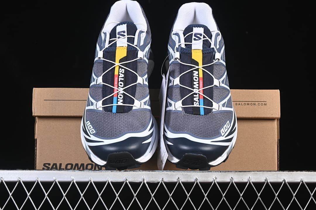 Front view of the pair displayed against a Salomon shoebox.