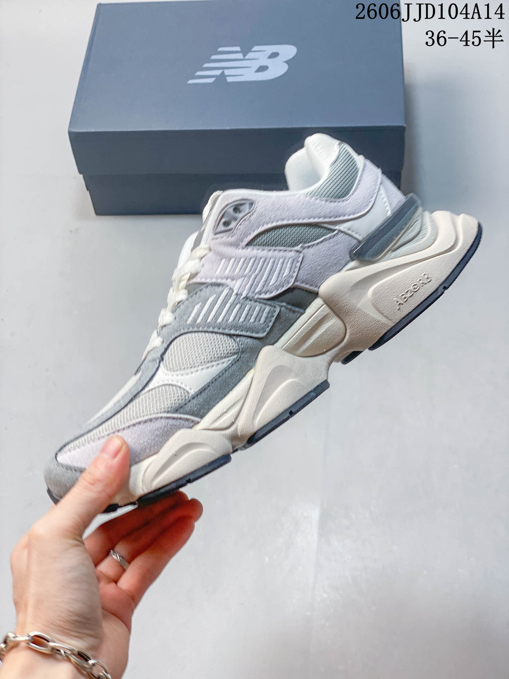 Side profile of the grey and lavender New Balance 9060 sneaker