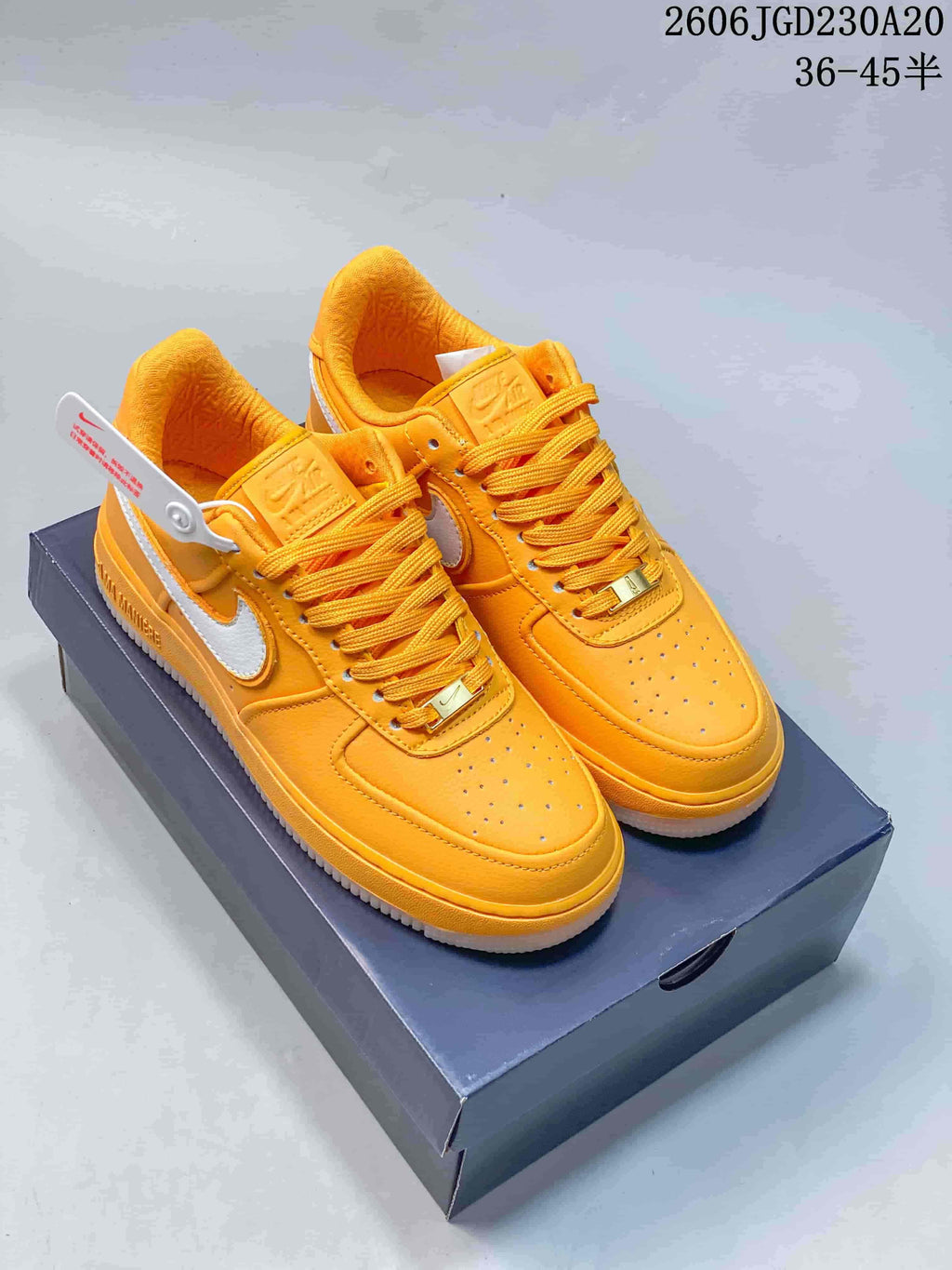 Pair of yellow Nike Air Force 1 low-top sneakers with white Swooshes on a shoe box
