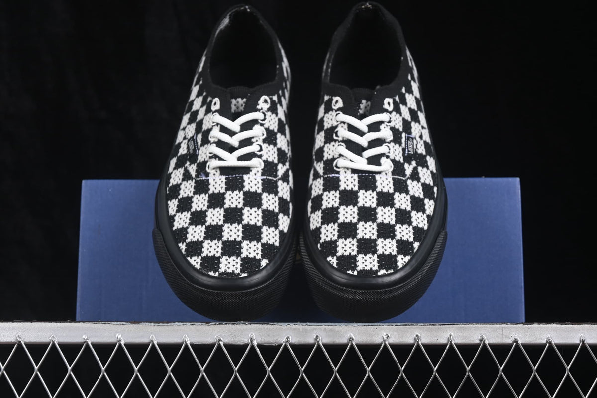 Top view of the pair showing the low-top silhouette, checkerboard uppers, white laces and black foxing.