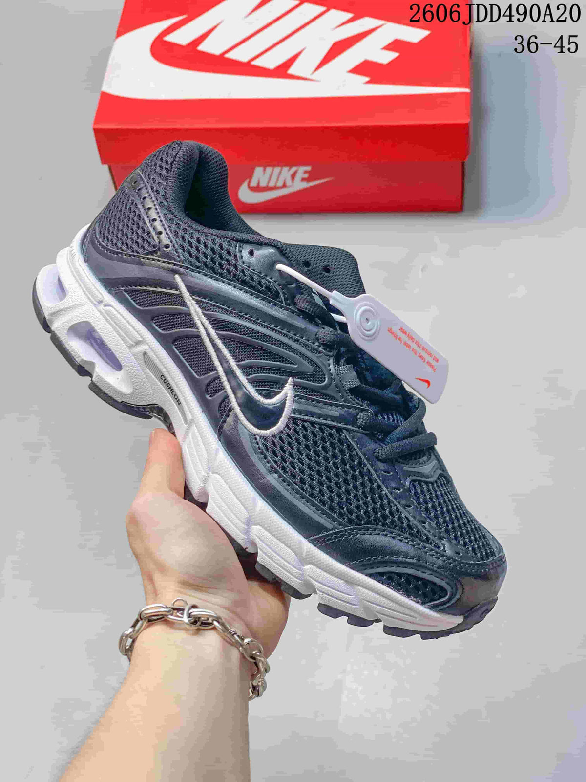 Dark mesh Nike Air Max Moto 2K sneaker with white Swoosh detail