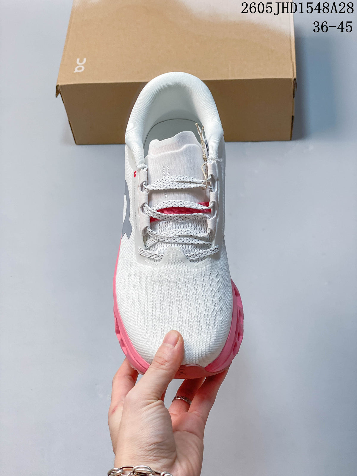 Front view of the shoe showing its laces and white patterned upper