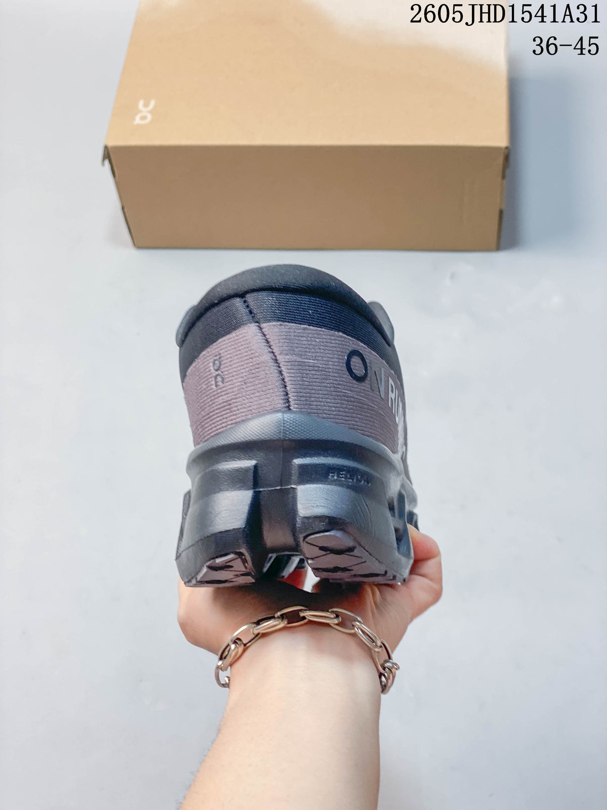 Rear view showing the heel and sculpted outsole of a charcoal running shoe.