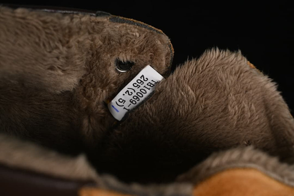 Close-up of the plush interior and a small label inside the boot.