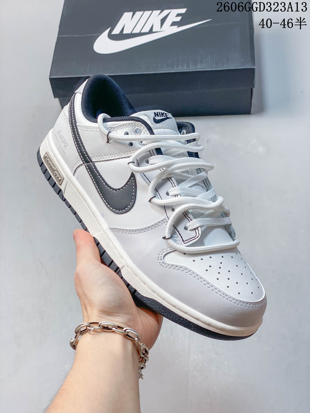Angled side view of a white Nike SB Dunk Low Pro sneaker with dark navy details
