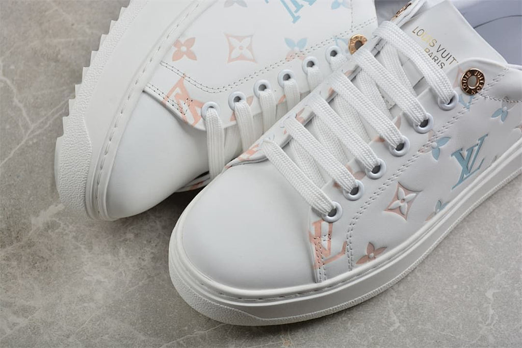 Close-up of white toe, laces, and pastel patterned panels
