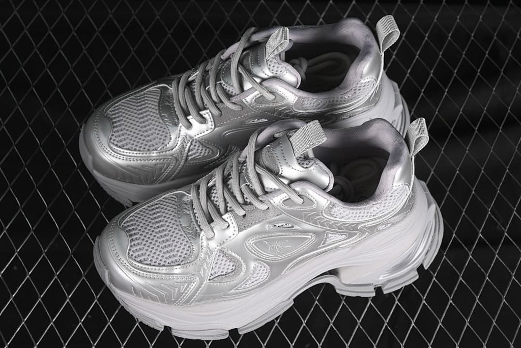Pair of silver chunky platform sneakers shown from above and the side.
