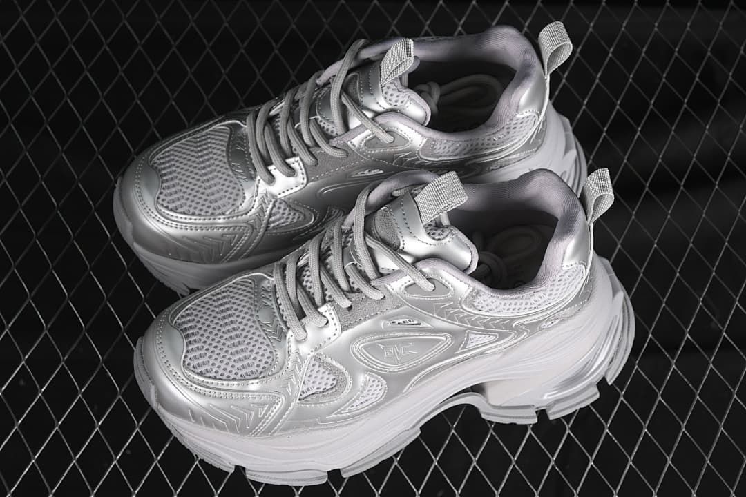 Pair of silver chunky platform sneakers shown from above and the side.