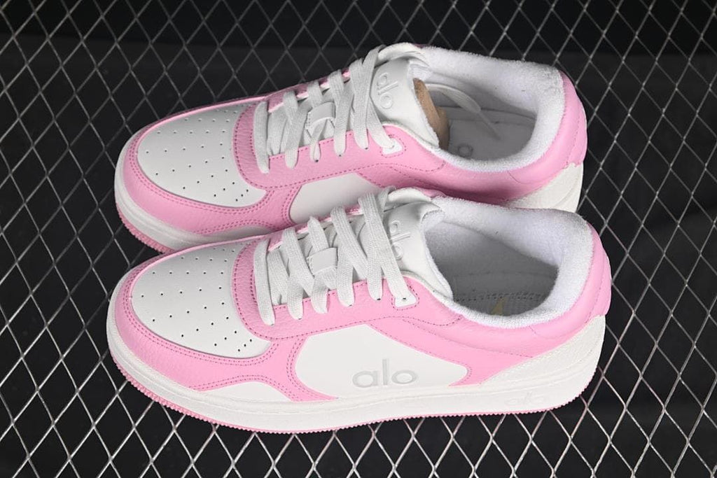 Pair of pink and white low-top sneakers viewed from above