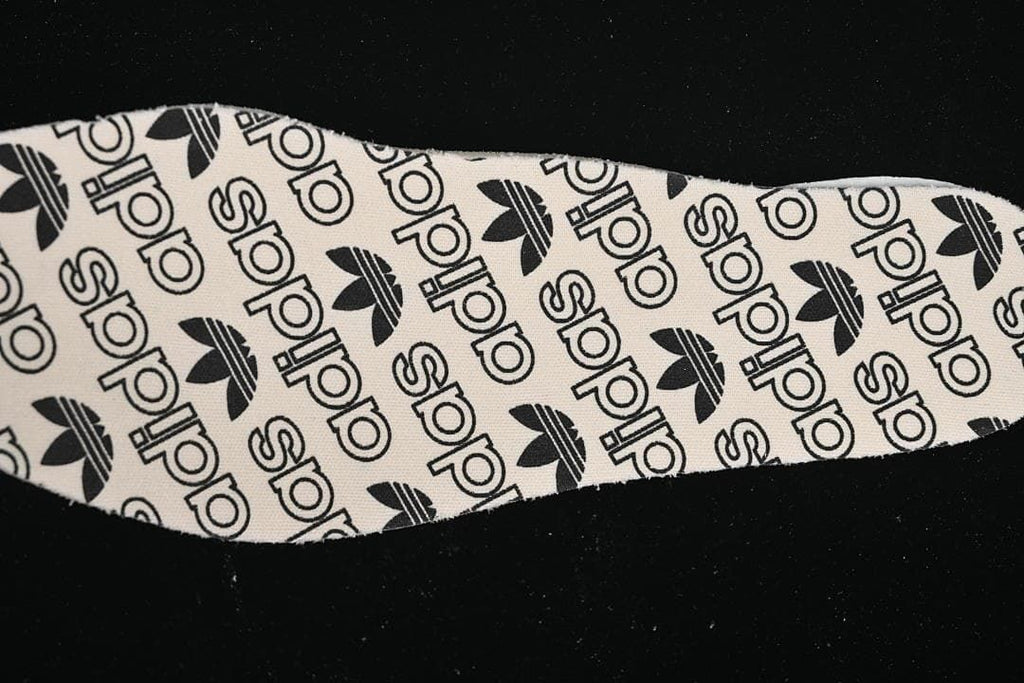 Close-up of the insole printed with adidas logos