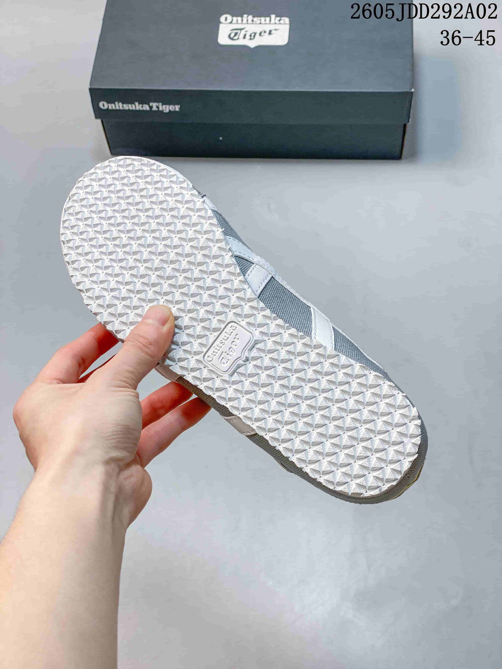 Close-up of the patterned white outsole on a gray slip-on sneaker