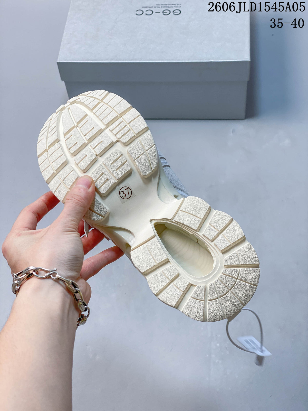 Underside of a chunky sneaker showing its textured cream outsole; sample size 37 is visible