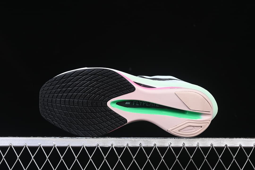 Underside view showing the black and pink-green outsole