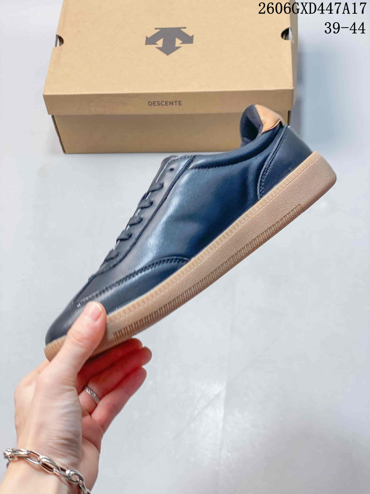 Side profile of a navy low-top sneaker with a gum-colored sole.