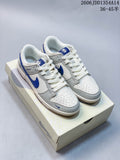 Pair of white and grey low-top sneakers with blue Swoosh details on a Nike Dunk box
