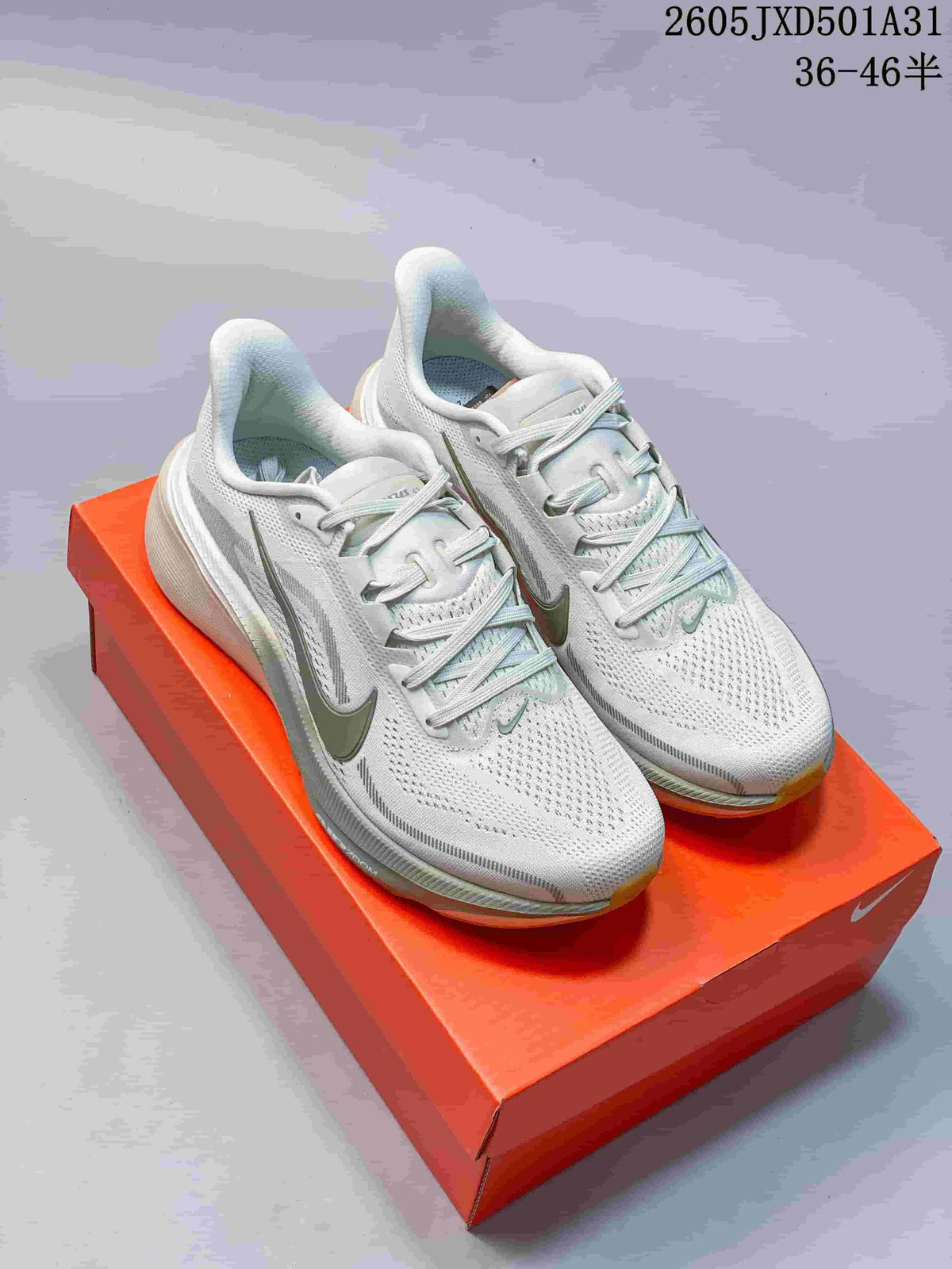 Pair of white and grey Nike Air Zoom Pegasus 42 running shoes displayed on an orange shoe box