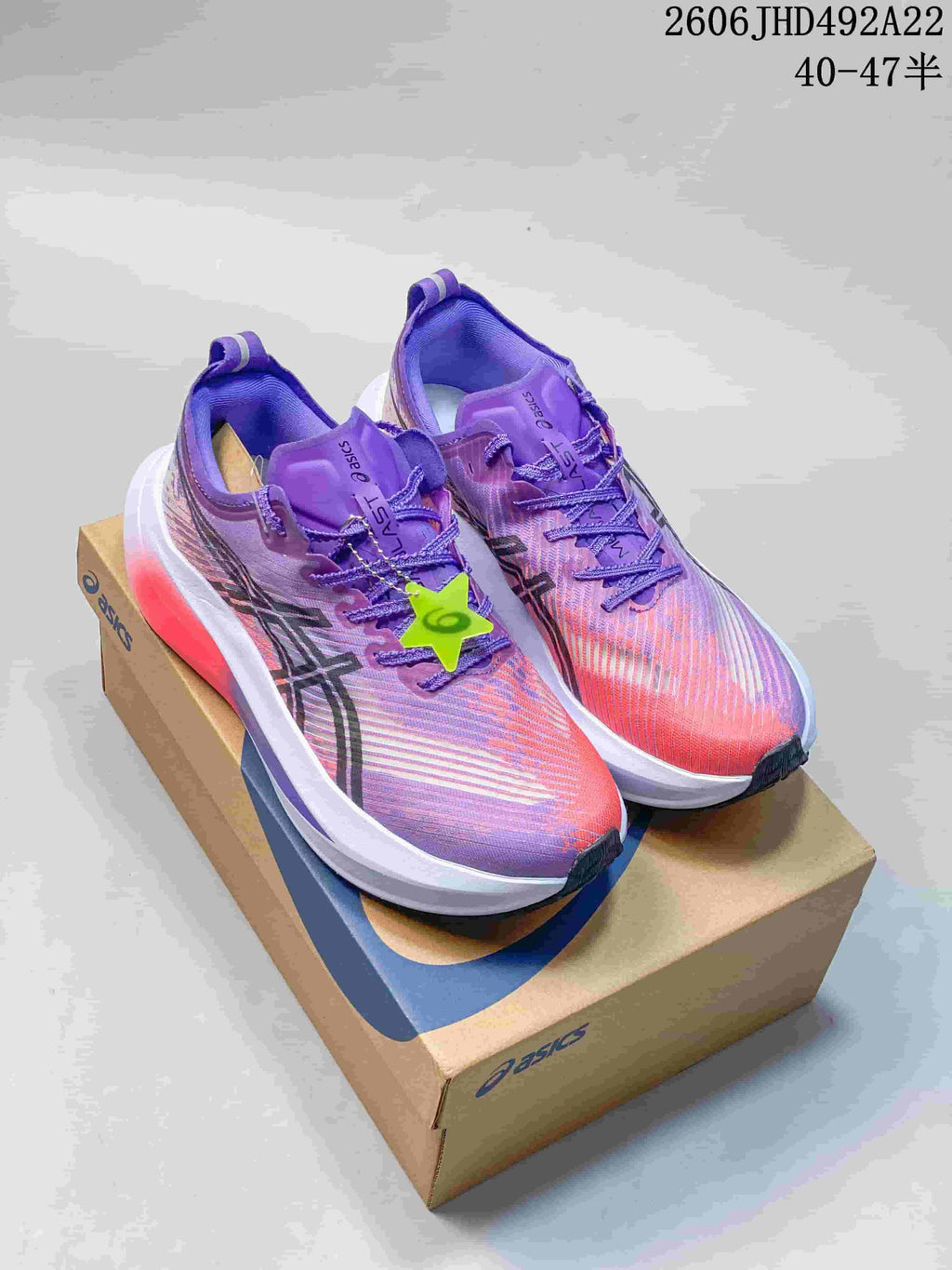 Purple and pink ASICS MEGABLAST shoes on a shoebox