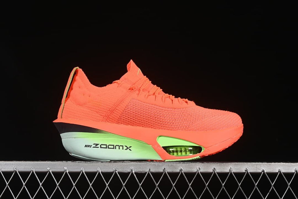 Side profile showing the coral upper and bright green cushioning details