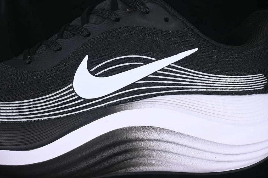Close-up of the white side Swoosh and layered sole on the black shoe