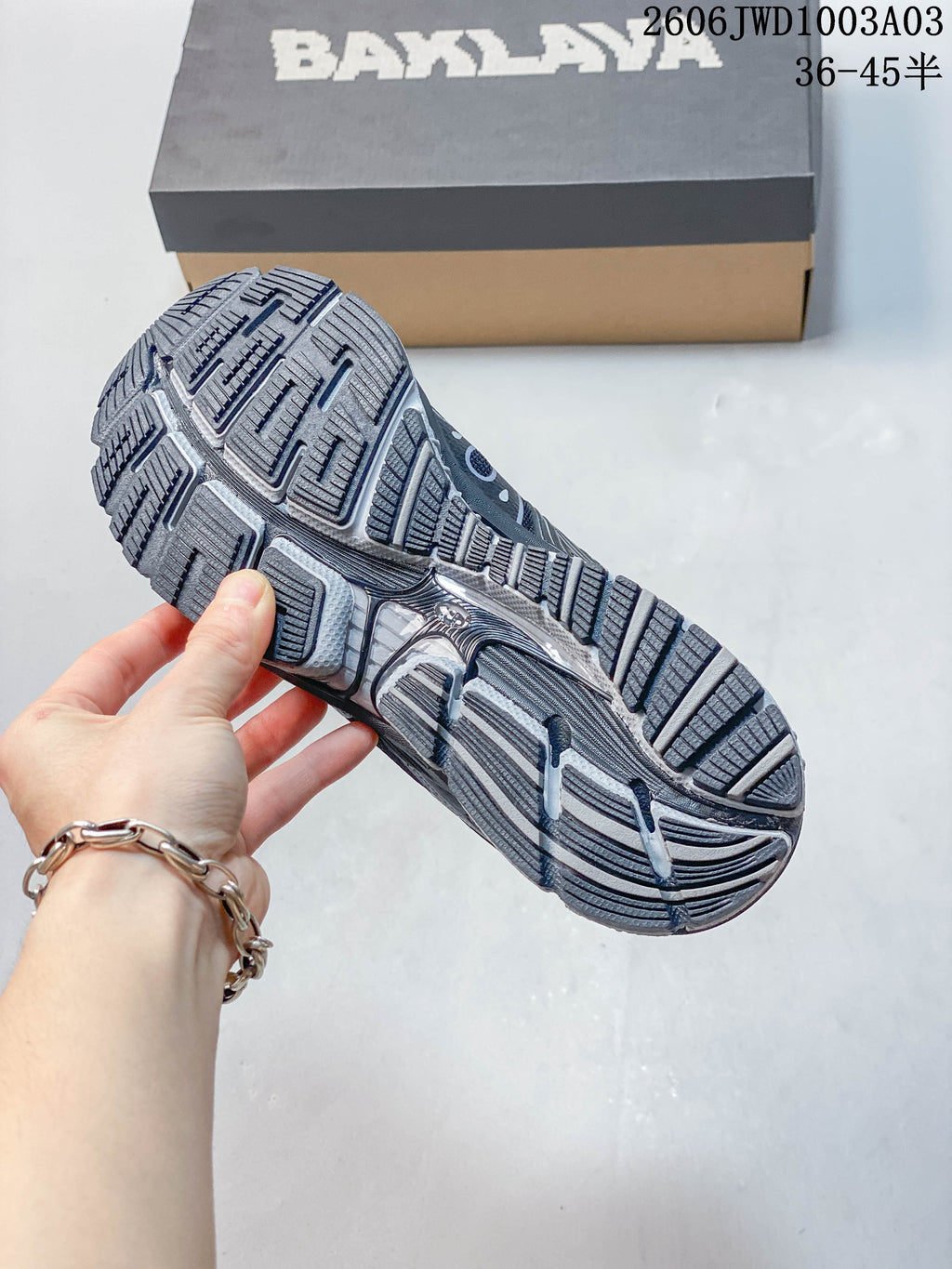Close-up of the sneaker outsole showing its segmented tread pattern.