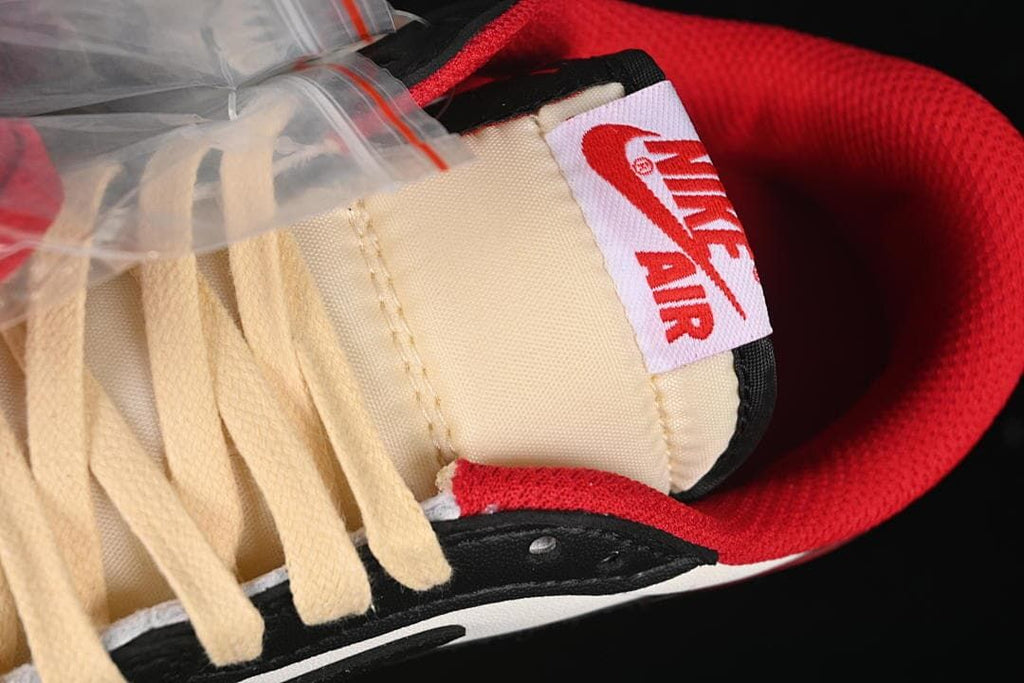 Close-up of cream laces, tongue label, and red collar lining