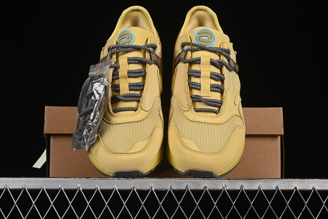 Front view of the pair with patterned laces and circular tongue accents.