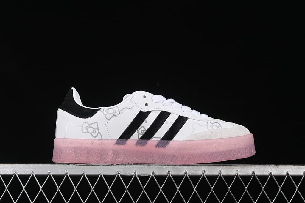 Side profile of the sneaker showing the white upper, black stripes, Hello Kitty graphics, and pink sole.