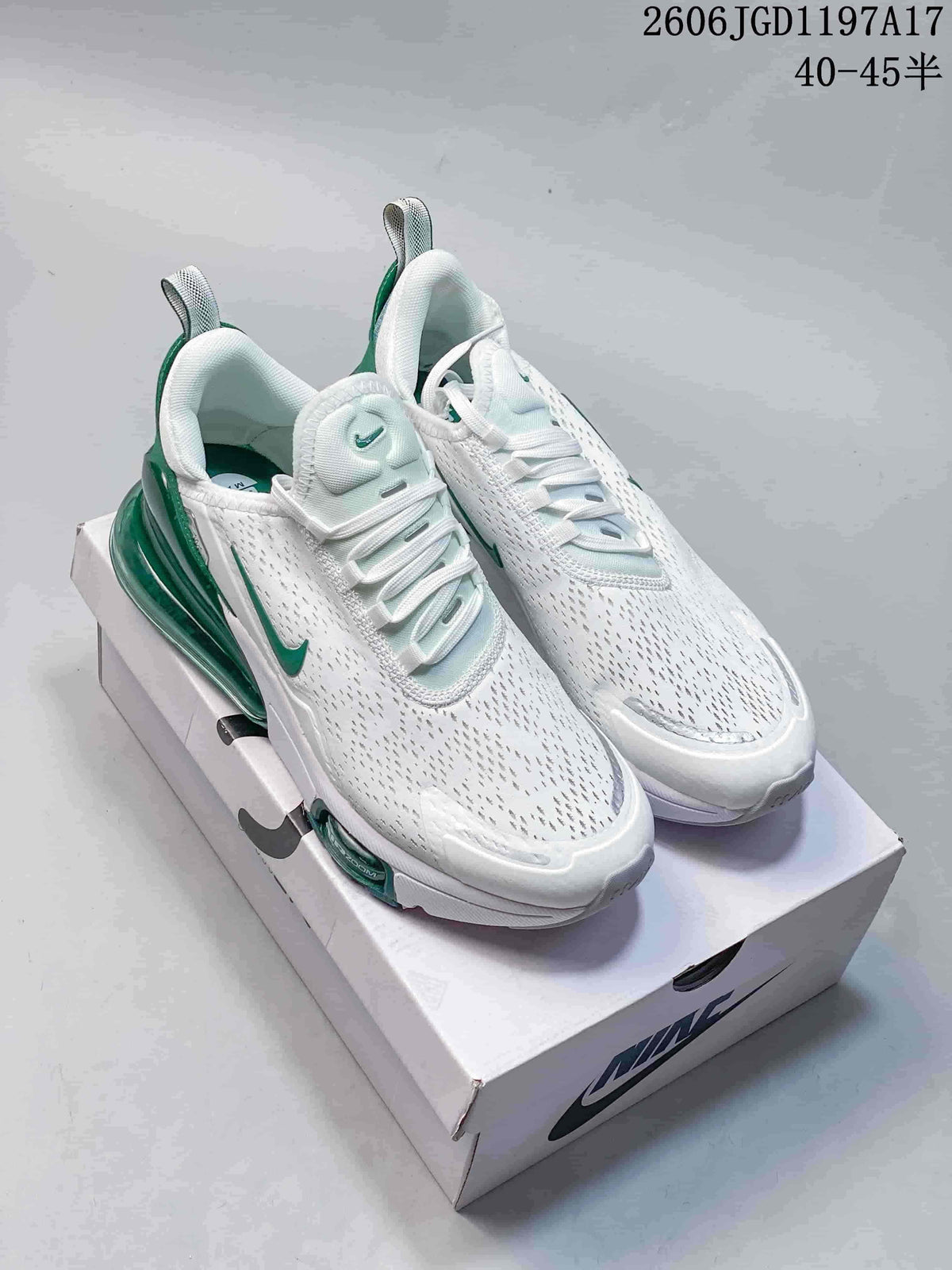 Pair of white Nike Air Max Pulse shoes with green accents.