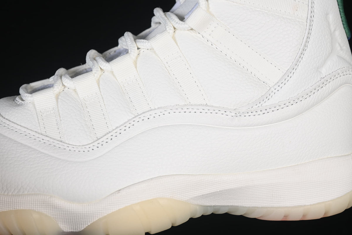 Close-up of the white upper, lace loops, and side stitching.