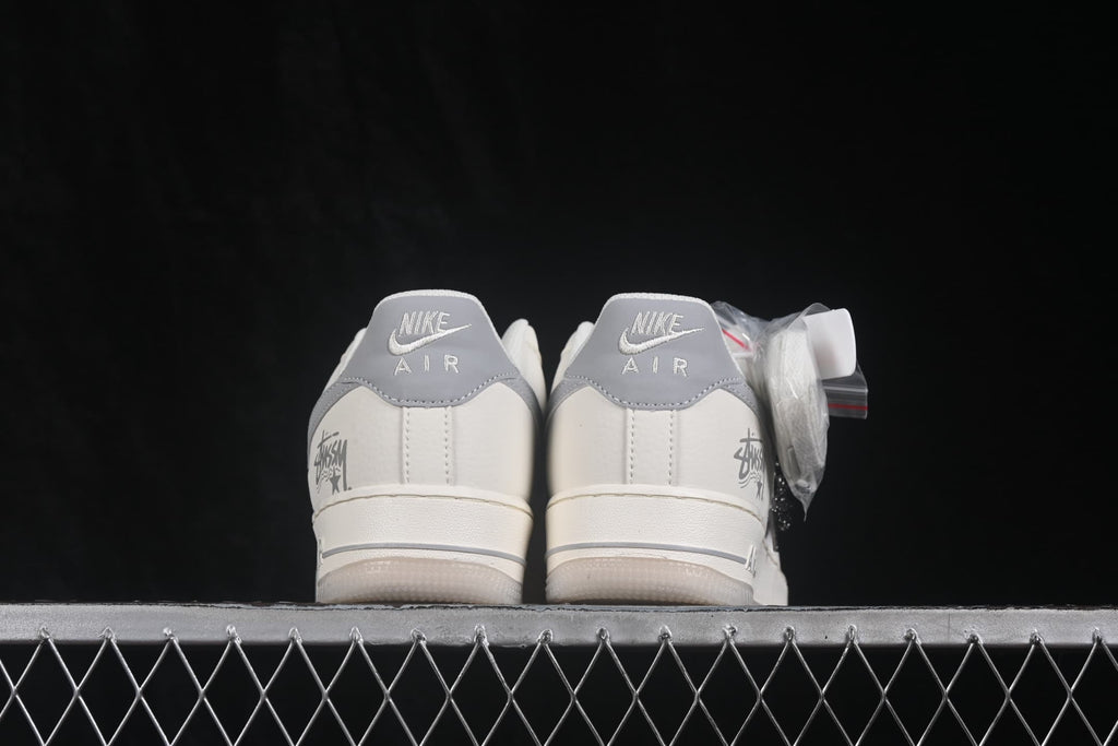 Rear view showing gray heel panels, Nike Air branding, and graphic heel details.