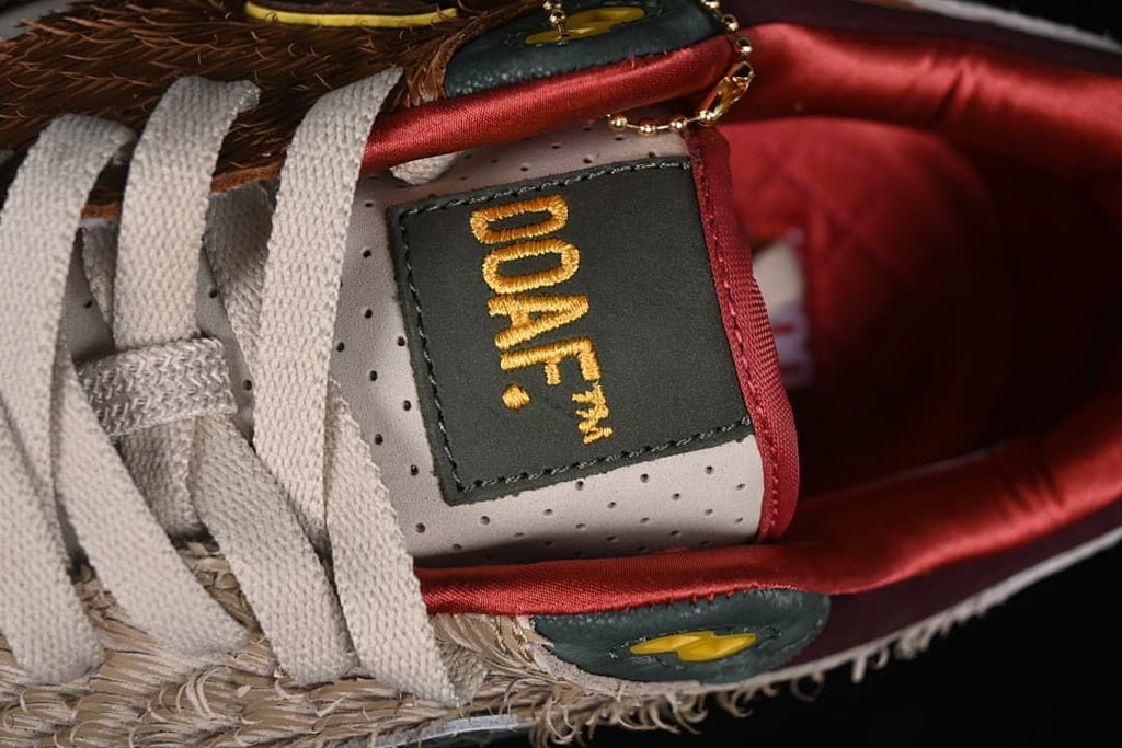 Close-up of the tongue label, laces, and decorative gold-tone chain.