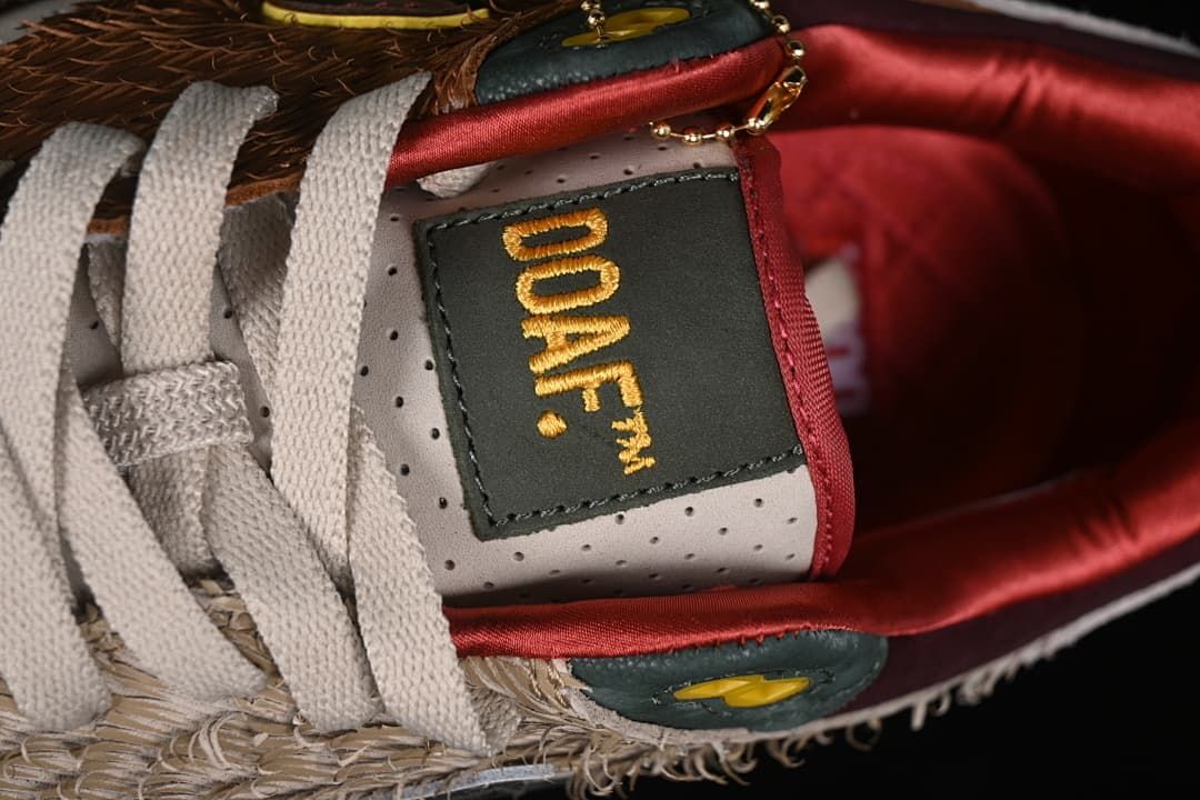 Close-up of the tongue label, laces, and decorative gold-tone chain.