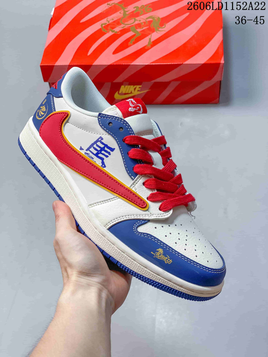 Low-top sneaker with white, royal blue, and red panels, graphic accents, and red laces; size range 36–45 is printed in the image.
