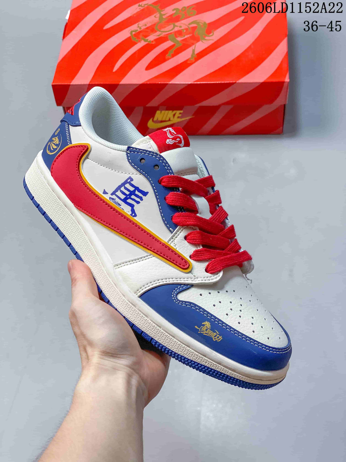 Low-top sneaker with white, royal blue, and red panels, graphic accents, and red laces; size range 36–45 is printed in the image.