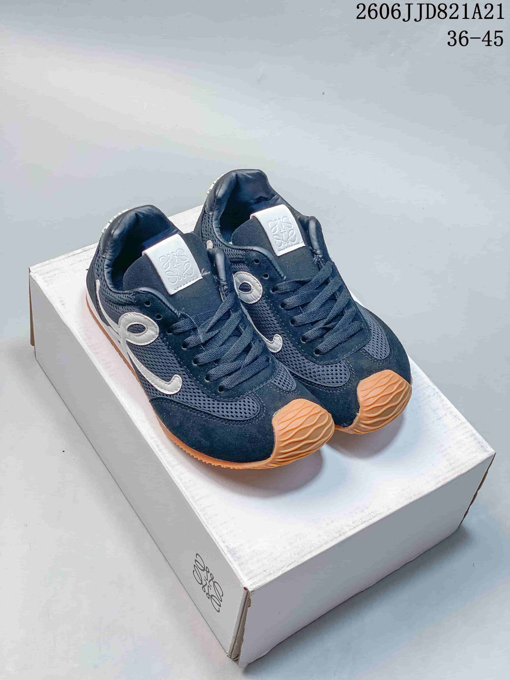 Pair of navy mesh sneakers with white side detailing and gum-tone outsoles