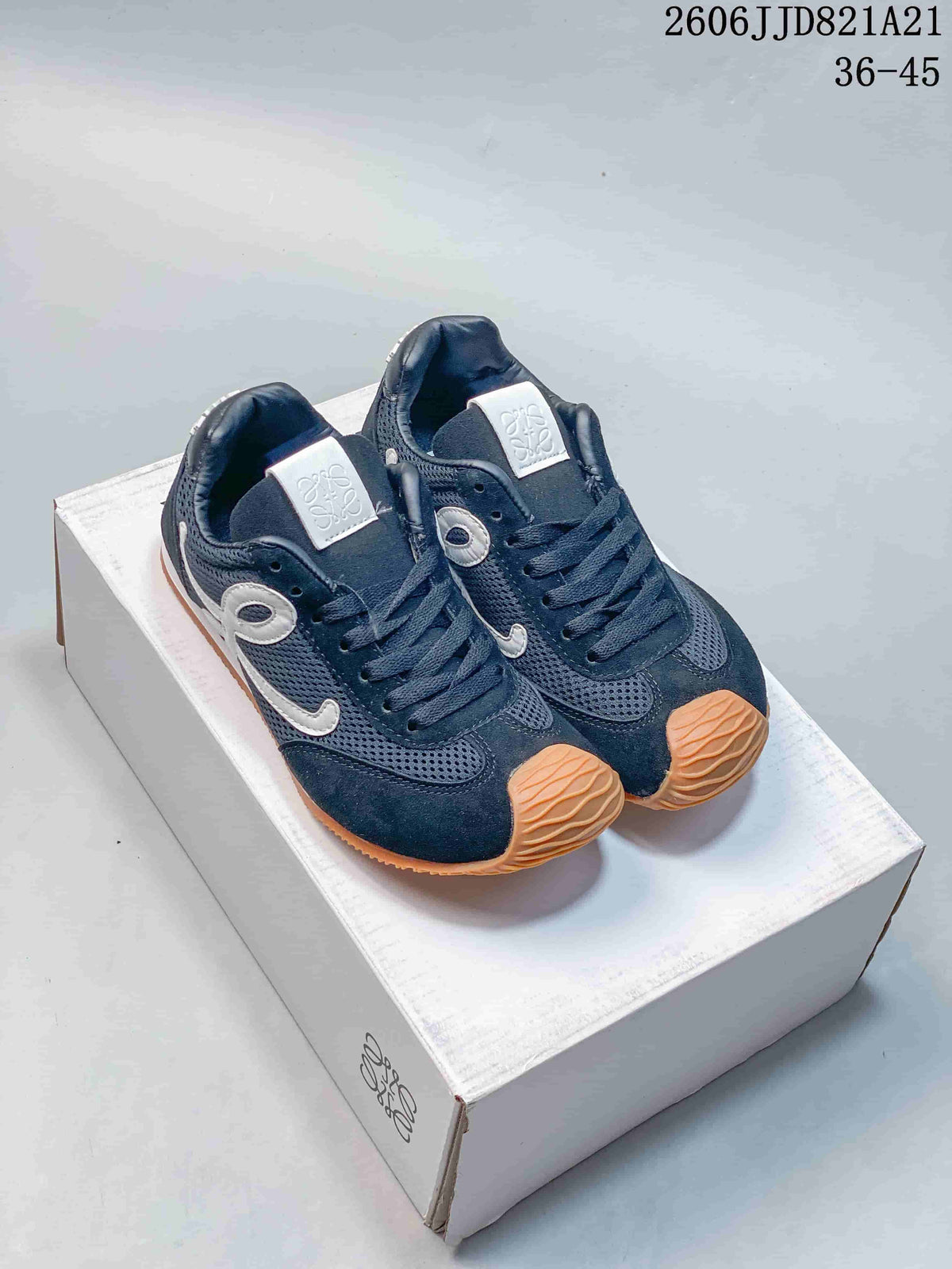 Pair of navy mesh sneakers with white side detailing and gum-tone outsoles