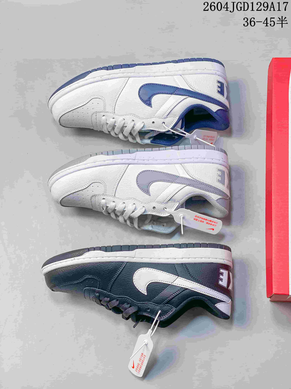 Side view of white-and-blue and dark navy Nike Big Low low-top sneakers.