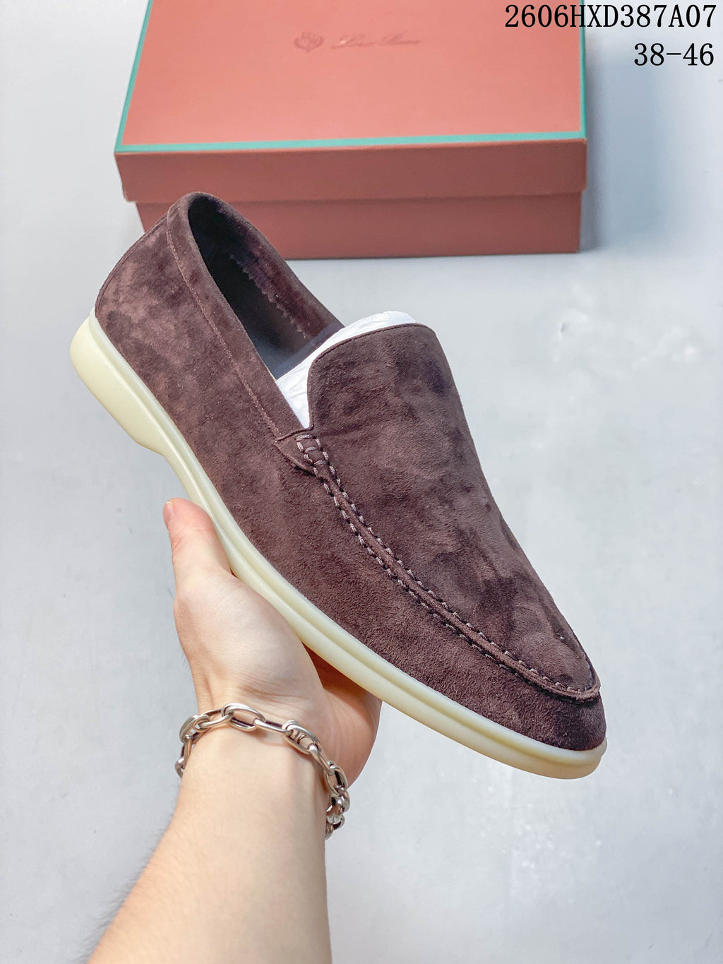 Close side view of the brown-toned loafer and its low-profile sole.