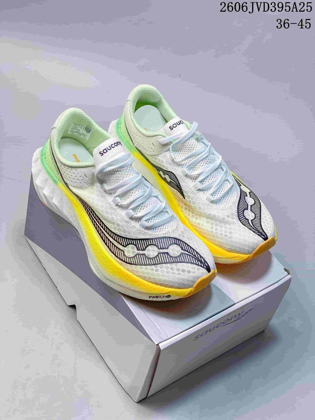 White Saucony Endorphin Speed 5 running shoes with yellow and green accents, displayed on a shoe box.