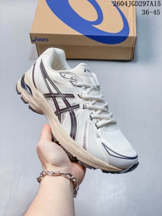 White ASICS sneaker with dark contrasting side-panel details and a layered sole, shown beside an ASICS box.