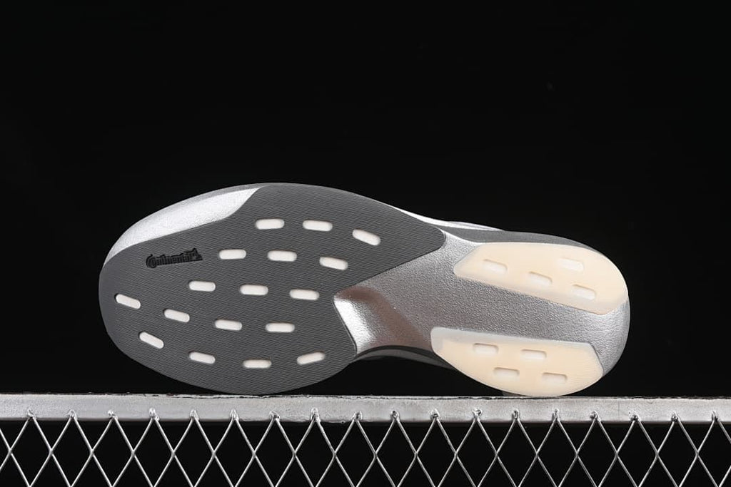 Outsole view showing patterned tread and segmented contact areas.