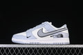 Side view of a white and light gray Nike SB Dunk Low style sneaker with North Face graphics on the heel