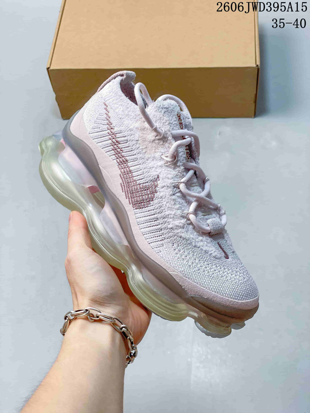 Pale grey and pink knit sneaker with a translucent-looking sculpted sole; image also shows the text 35–40.