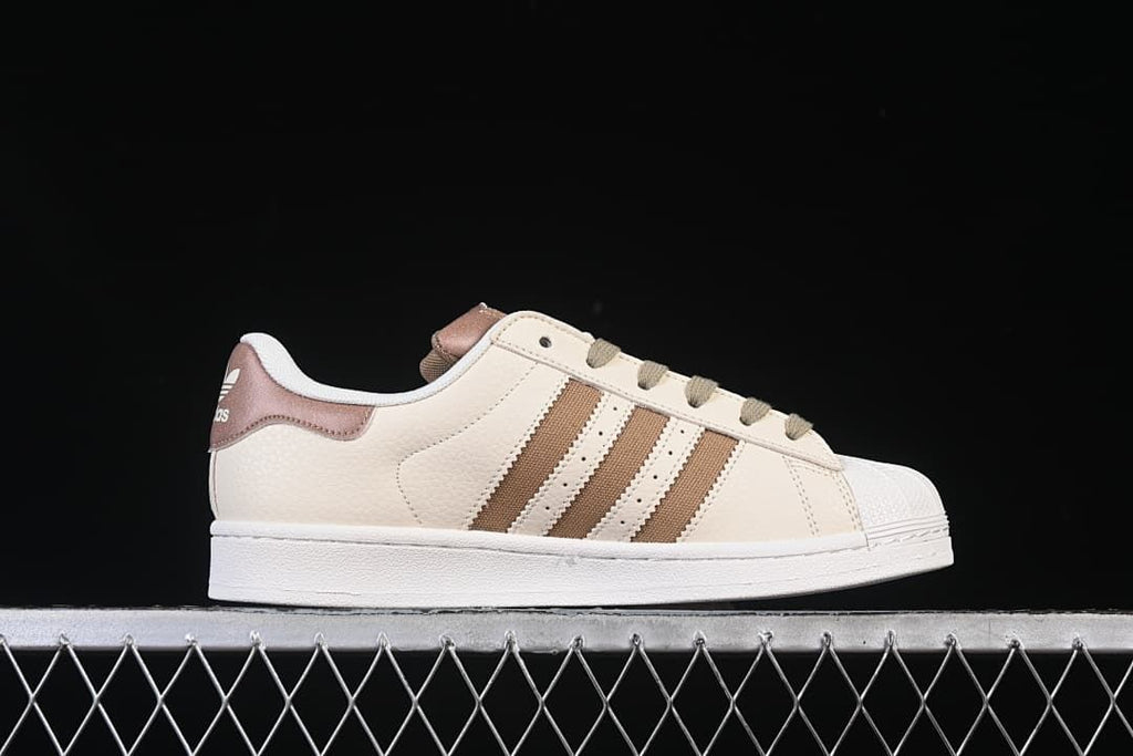 Side profile of the cream and brown Superstar II sneaker.