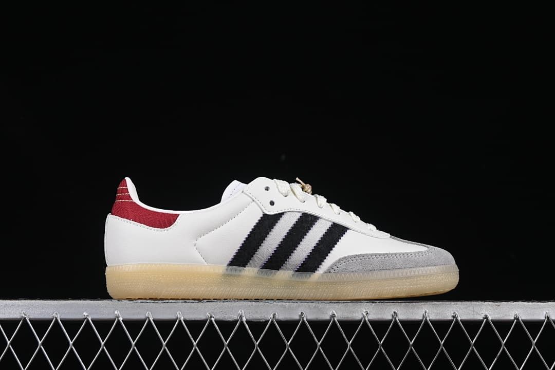 Side profile of the white, black, gray, and red Samba OG sneaker