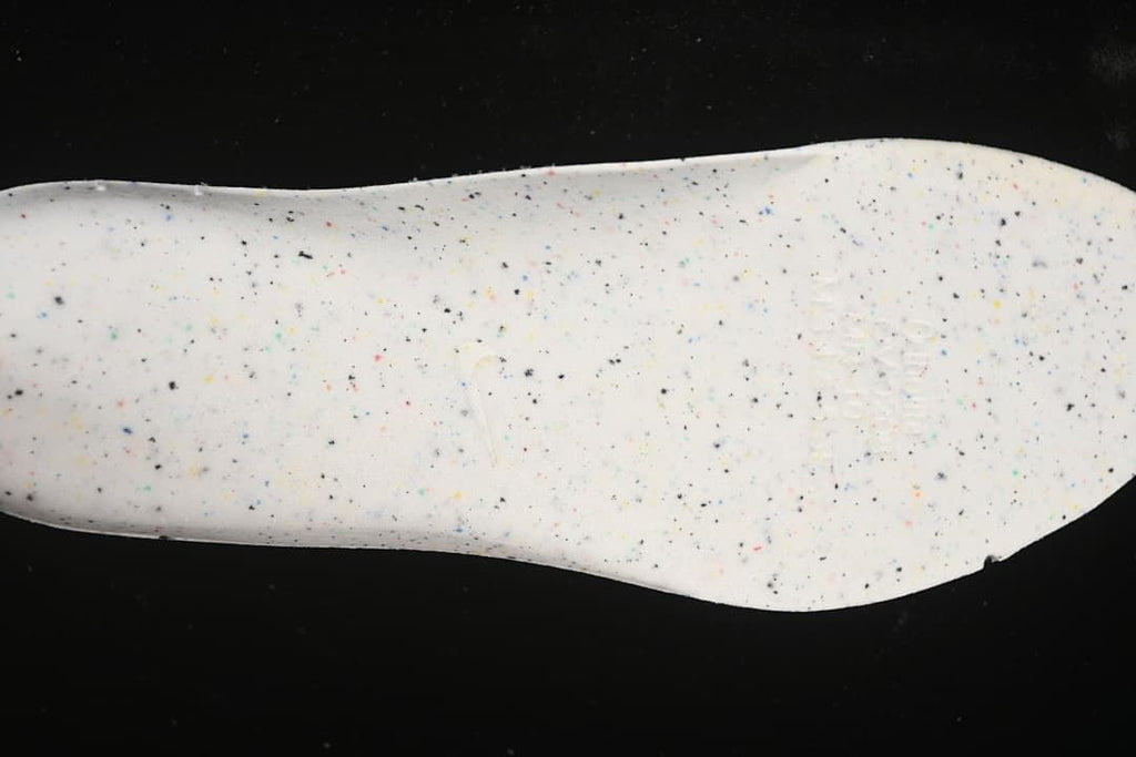 Close-up of a white shoe insert with multicolored speckles