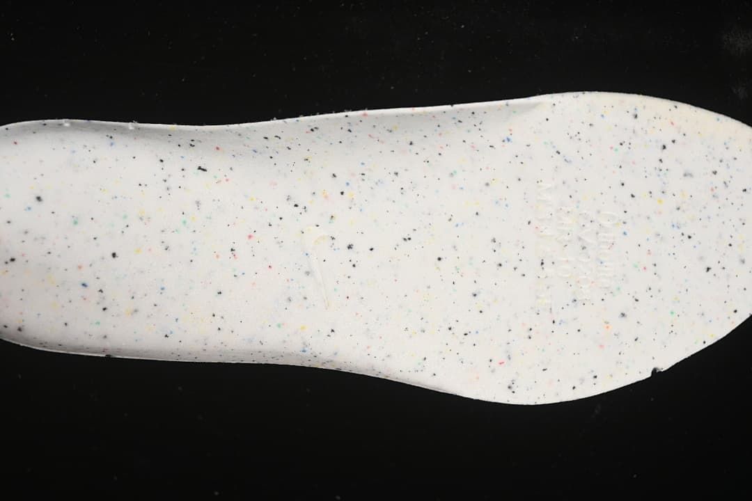 Close-up of a white shoe insert with multicolored speckles