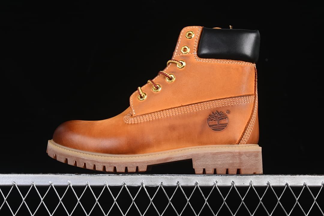 Side view of a wheat-colored Timberland-style 6-inch lace-up boot with black padded collar and lugged sole